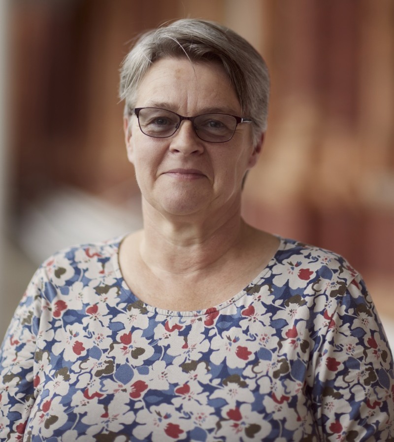 Woman in floral dress and dark glasses